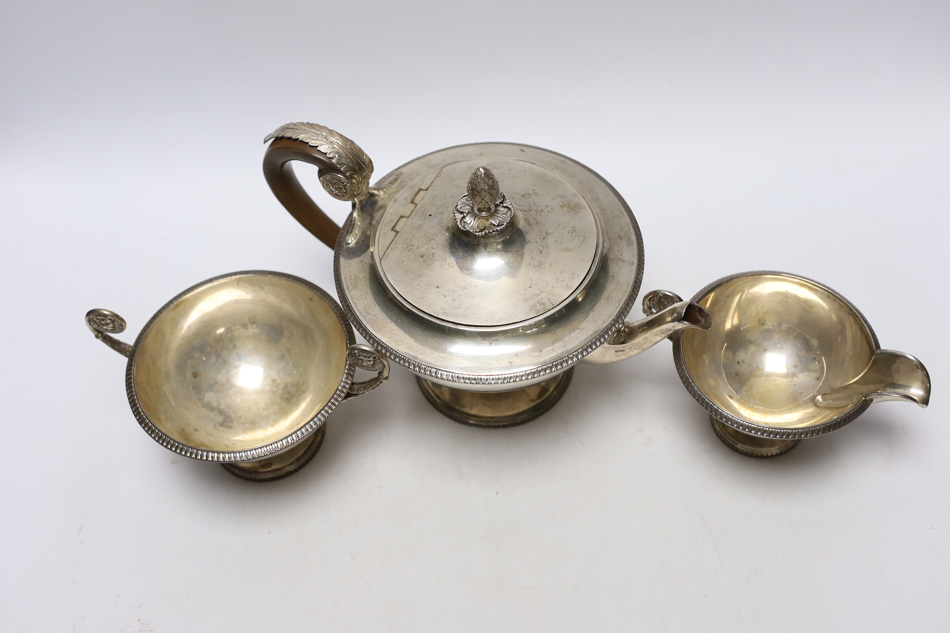 A 1930's silver circular pedestal three piece tea set, Goldsmiths & Silversmiths Co Ltd, London, Sheffield, 1933, sugar bowl, London, 1936, 34.3oz.